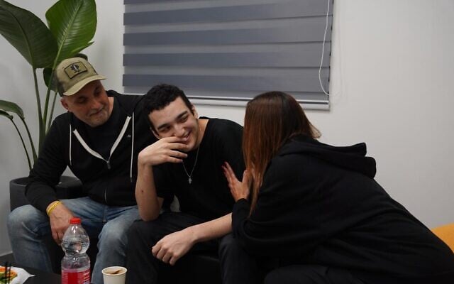 Released hostage Edan Alexander, center, reunites with his parents at an IDF base near Re'im, May 12, 2025. (Israel Defense Forces)