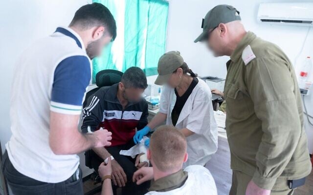 IDF troops treat Syrians at a medical facility near the Druze village of Hader, southern Syria, in a handout photo issued on May 28, 2025. (Israel Defense Forces)