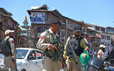 Policemen stand guard at a market in Srinagar, Jammu and Kashmir, May 12, 2025. (Basit Zargar/ZUMA Press Wire via Reuters)