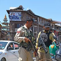 Policemen stand guard at a market in Srinagar, Jammu and Kashmir, May 12, 2025. (Basit Zargar/ZUMA Press Wire via Reuters)