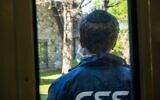 A CSS volunteer stands guard outside a synagogue during a security training drill, in Westchester County, New York, April 28, 2025. (Luke Tress/Times of Israel)