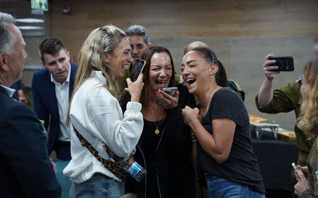 Yael Alexander (center) speaks on the phone with her son Edan Alexander, following his release from Hamas captivity, May 12, 2025. (Israel Defense Forces)