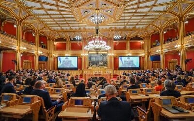 Illustrative: Ukrainian President Volodymyr Zelensky is seen on large screens as he addresses members of Norway's Parliament, The Storting, in Oslo, Norway on March 30, 2022. (Heiko JUNGE / various sources / AFP)