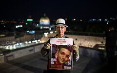 Varda Ben Baruch holds an image of her grandson, hostage Edan Alexander, in Jerusalem on October 25, 2023. (Yuri CORTEZ / AFP)