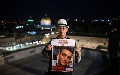 Varda Ben Baruch holds an image of her grandson, hostage Edan Alexander, in Jerusalem on October 25, 2023. (Yuri CORTEZ / AFP)