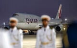 FILE: This handout picture provided by the UAE Presidential Court shows the Qatar Amiri Flight Boeing 747-8 aircraft carrying Qatar's Emir upon landing at Abu Dhabi's Presidential Airport on November 9, 2023. (Abdulla AL-BEDWAWI / UAE PRESIDENTIAL COURT / AFP)