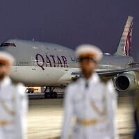 FILE: This handout picture provided by the UAE Presidential Court shows the Qatar Amiri Flight Boeing 747-8 aircraft carrying Qatar's Emir upon landing at Abu Dhabi's Presidential Airport on November 9, 2023. (Abdulla AL-BEDWAWI / UAE PRESIDENTIAL COURT / AFP)