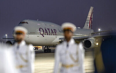 FILE: This handout picture provided by the UAE Presidential Court shows the Qatar Amiri Flight Boeing 747-8 aircraft carrying Qatar's Emir upon landing at Abu Dhabi's Presidential Airport on November 9, 2023. (Abdulla AL-BEDWAWI / UAE PRESIDENTIAL COURT / AFP)