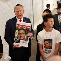 Republican US presidential nominee Donald Trump poses for photos with the family of Edan Alexander at Ohel Chabad Lubavitch on October 7, 2024, in New York City. (Photo by Michael M. Santiago / Getty Images via AFP)
