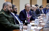 This handout picture released by the official Syrian Arab News Agency (SANA) shows Syria's Defence Minister Murhaf Abu Qasra (L) and Justice Minister Mazhar al-Wais (2nd-L) looking on as Minister of Higher Education Marwan al-Halabi (C) speaks during the first meeting of the new cabinet ministers in Damascus on April 7, 2025. Syria's interim president Ahmed al-Sharaa announced the formation of a new government on March 29. (SANA/Handout/AFP)