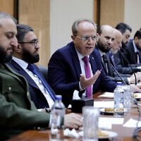 This handout picture released by the official Syrian Arab News Agency (SANA) shows Syria's Defence Minister Murhaf Abu Qasra (L) and Justice Minister Mazhar al-Wais (2nd-L) looking on as Minister of Higher Education Marwan al-Halabi (C) speaks during the first meeting of the new cabinet ministers in Damascus on April 7, 2025. Syria's interim president Ahmed al-Sharaa announced the formation of a new government on March 29. (SANA/Handout/AFP)