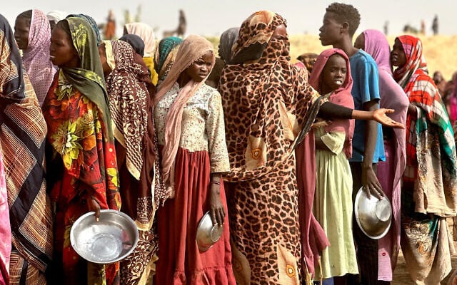 People who fled the Zamzam camp for the internally displaced after it fell under RSF control queue for food rations in a makeshift encampment in an open field near the town of Tawila in war-torn Sudan's western Darfur region on April 13, 2025 (AFP) People who fled the Zamzam camp for the internally displaced after it fell under RSF control queue for food rations in a makeshift encampment in an open field near the town of Tawila in war-torn Sudan's western Darfur region on April 13, 2025 (AFP)