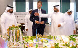 Eric Trump, executive vice president of the Trump Organization and the US president's son, looks over the proposed plan ahead of the signing ceremony with Qatar's Diar and Dar Global in Doha on April 30, 2025. (Karim Jaafar/AFP)