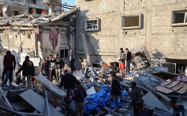 People look for survivors in the rubble of a building hit in an Israeli strike in Bureij in the central Gaza Strip on May 2, 2025. (Eyad BABA / AFP)