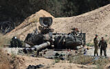Soldiers stand near an Israeli army mobile canon at a position by Israel's border with the Gaza Strip, on May 6, 2025. (Jack GUEZ / AFP)