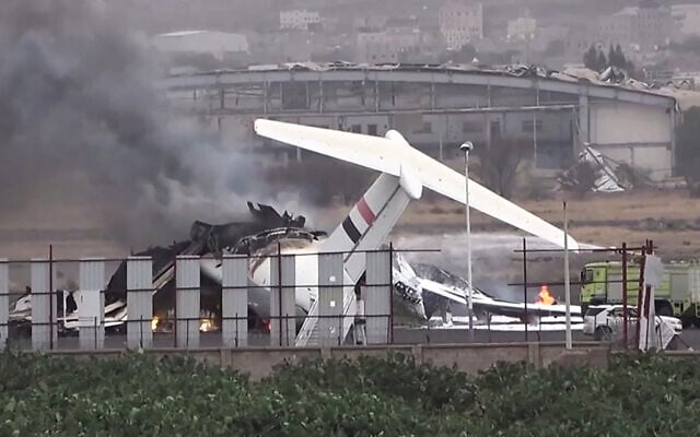 This handout picture released by the Huthi-affiliated branch of the Yemeni News Agency SABA on May 6, 2025, shows a firefighter truck extinguishing fire from a burning airplane at Sanaa international airport after Israel's military warplanes struck Yemen's rebel-held capital Sanaa. (SABA / AFP)
