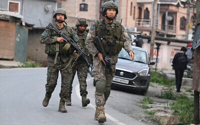 Indian soldiers walk along a street in Wuyan near Indian-administered Kashmir's main city of Srinagar after a loud explosion was heard on May 7, 2025. (TAUSEEF MUSTAFA / AFP)
