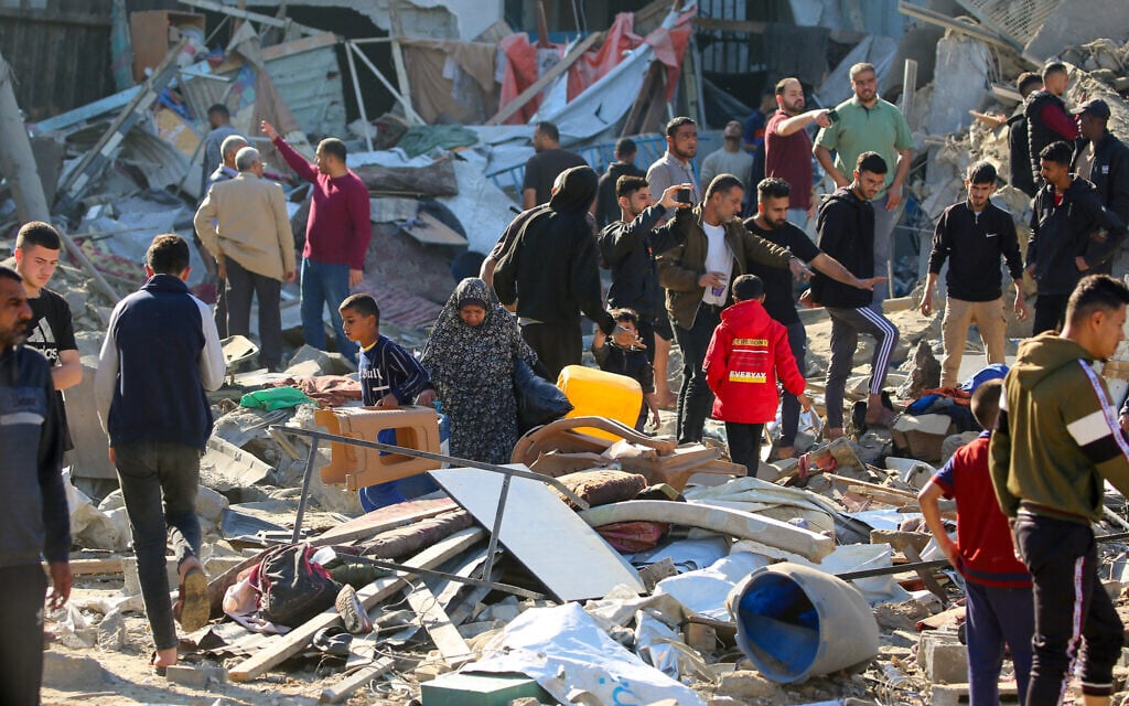 Palestinians sift through destroyed shelters at a UNRWA school housing displaced people, following an Israeli strike in the Bureij refugee camp in the center of the Gaza Strip, on May 7, 2025. (Eyad BABA / AFP)