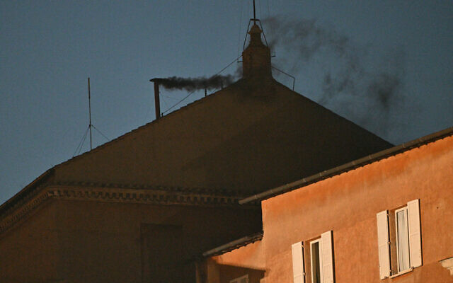 Black smoke rising from the chimney of the Sistine Chapel signaling that cardinals failed to elect a new pope in the first ballot of their conclave in the Vatican on May 7, 2025. (Andreas SOLARO / AFP)