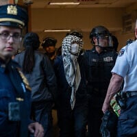 Pro-Palestinian, anti-Israel protesters are escorted out of Columbia University's Butler Library after being arrested for occupying the library space on May 7, 2025, in New York City.(Spencer Platt/Getty Images/AFP)