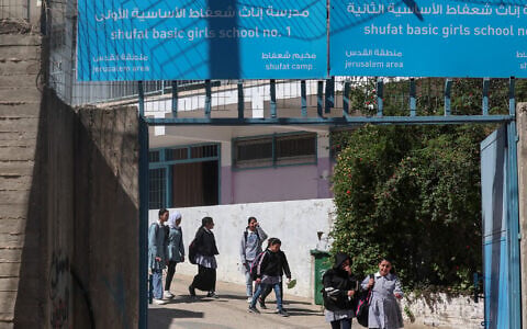 Illustrative: Palestinian schoolgirls leave a UNRWA school in the Shuafat refugee camp in East Jerusalem on May 8, 2025, as Israeli security forces prepared to close the school. (Ahmad GHARABLI / AFP)