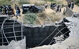 Residents gather as police personnel inspect the site where an alleged drone was shot down in Karachi on May 8, 2025. Pakistan's army said it shot down 25 Israeli-made Indian drones (Photo by Rizwan TABASSUM / AFP)