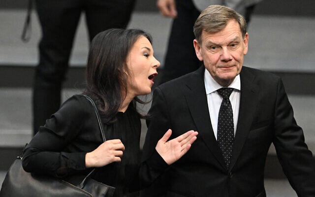 Former German Foreign Minister Annalena Baerbock (L) and her successor German Foreign Minister Johann Wadephul talk as they arrive to attend a commemoration ceremony marking the 80th anniversary of Germany's surrender that ended the Second World War in Europe, on May 8, 2025 at the Bundestag, in Berlin. (RALF HIRSCHBERGER / AFP) Former German Foreign Minister Annalena Baerbock (L) and her successor German Foreign Minister Johann Wadephul talk as they arrive to attend a commemoration ceremony marking the 80th anniversary of Germany's surrender that ended the Second World War in Europe, on May 8, 2025 at the Bundestag, in Berlin. (RALF HIRSCHBERGER / AFP)