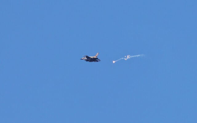 An Israeli fighter jet drops flares above the Gaza Strip as pictured from a position near the southern Israeli border with the coastal enclave, on May 8. (Menahem Kahana/AFP) An Israeli fighter jet drops flares above the Gaza Strip as pictured from a position near the southern Israeli border with the coastal enclave, on May 8. (Menahem Kahana/AFP)