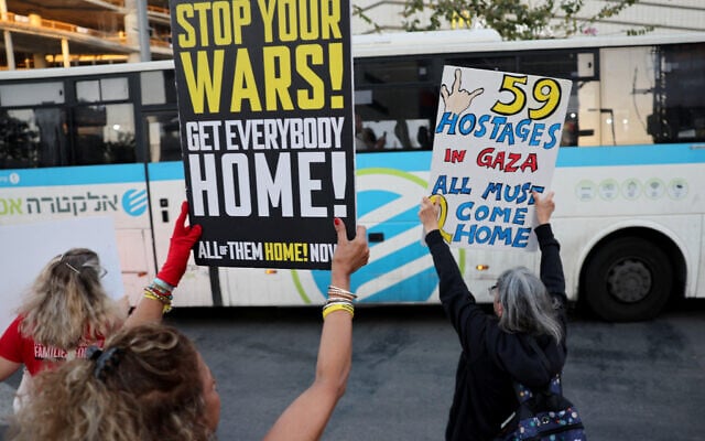Demonstrators raise placards during an anti-government protest calling for the end of the war and for action to secure the release of hostages held by Palestinian terrorists in the Gaza Strip, in front of the Defense Ministry headquarters in Tel Aviv on May 8, 2025. (Photo by Jack GUEZ / AFP) Demonstrators raise placards during an anti-government protest calling for the end of the war and for action to secure the release of hostages held by Palestinian terrorists in the Gaza Strip, in front of the Defense Ministry headquarters in Tel Aviv on May 8, 2025. (Photo by Jack GUEZ / AFP)