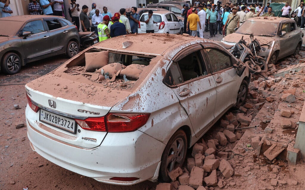 Damaged vehicles are pictured following overnight Pakistani artillery shelling in Jammu on May 10, 2025.  (Photo by Rakesh BAKSHI / AFP)