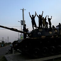 Pakistani people flash victory signs as they celebrate after the ceasefire between Pakistan and India, in Multan on May 10, 2025 (Shahid Saeed MIRZA / AFP)