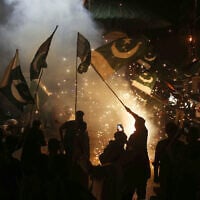 Pakistanis wave the national flag as they celebrate after the ceasefire between Pakistan and India, in Hyderabad, Sindh province, on May 10, 2025. (Photo by Husnain ALI / AFP)