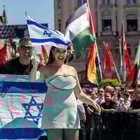 Israeli singer Yuval Raphael, representing Israel with the song, 'New Day Will Rise,' walks on the turquoise carpet next to the Basel Town Hall, with protesters' Palestinian flags behind, during the opening ceremony of the Eurovision Song Contest 2025  in Basel on May 11, 2025. (Fabrice COFFRINI / AFP)