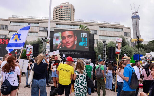 People gather ahead of the expected release of hostage Israeli-US soldier Edan Alexander at Hostages Square Tel Aviv on May 12, 2025 (Menahem Kahana / AFP)