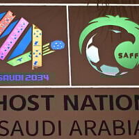 The logo of the Saudi 2034 FIFA World Cup football tournament is displayed on a wall at the Ministry of Media in Riyadh on May 13, 2025. (Giuseppe CACACE / AFP)