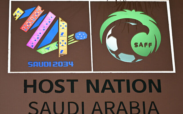 The logo of the Saudi 2034 FIFA World Cup football tournament is displayed on a wall at the Ministry of Media in Riyadh on May 13, 2025. (Giuseppe CACACE / AFP) The logo of the Saudi 2034 FIFA World Cup football tournament is displayed on a wall at the Ministry of Media in Riyadh on May 13, 2025. (Giuseppe CACACE / AFP)