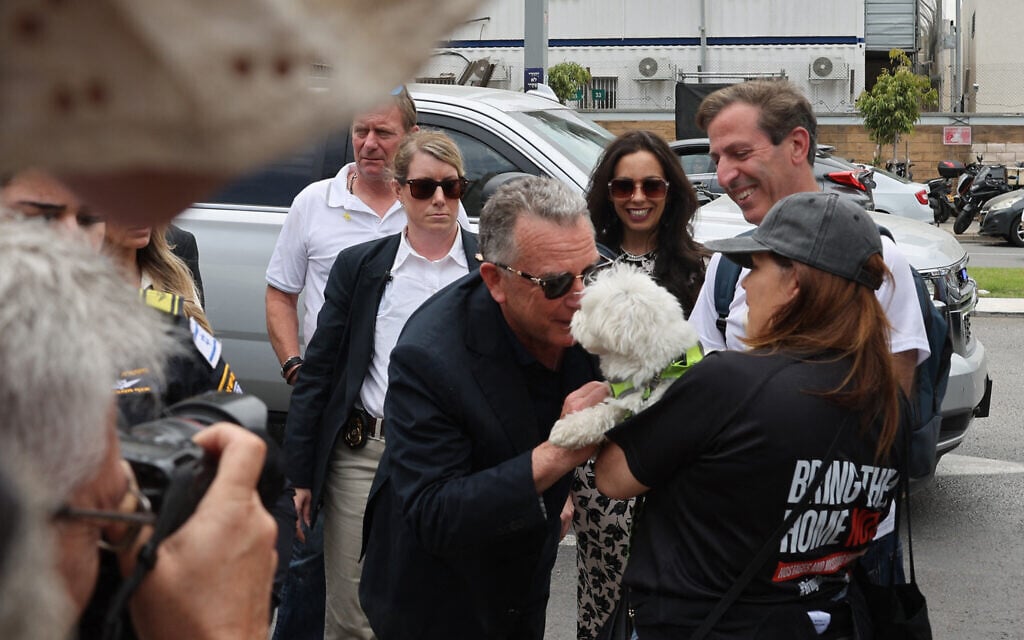 US Special Envoy to the Middle East Steve Witkoff snuffles Gucci the dog as he speaks to Hagit and Ruby Chen in Hostages Square in Tel Aviv, on May 13, 2025. (Jack GUEZ / AFP)