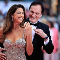US film director Quentin Tarantino and his wife, Israeli singer Daniella Pick, arrive for the Opening Ceremony and the screening of the film "Partir un Jour" (Bye Bye), at the 78th edition of the Cannes Film Festival in Cannes, southern France, on May 13, 2025. Pick is wearing a yellow ribbon pin in support of the hostages held by Hamas terrorists in Gaza. (Valery Hache/AFP)