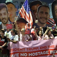 Relatives and supporters of Israelis held hostage in Gaza by Palestinian terrorists lift placards and Israeli flags as they call on the US to intervene for their release, in front of the US embassy branch office in Tel Aviv, on May 13, 2025. (Jack Guez/AFP)