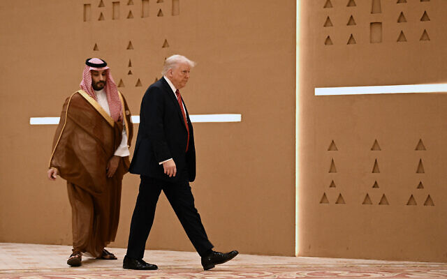 US President Donald Trump (right) walks alongside Saudi Crown Prince Mohammed Bin Salman ahead of a group picture with Gulf leaders during the Gulf Cooperation Council summit in in Riyadh on May 14, 2025. (Photo by Brendan SMIALOWSKI / AFP)