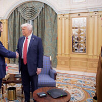 A handout picture provided by the Saudi Royal Palace shows Saudi Crown Prince Mohammed bin Salman (R) watching as US President Donald Trump (C) shakes hands with Syria's interim president Ahmed al-Sharaa in Riyadh on May 14, 2025 (Bandar AL-JALOUD / Saudi Royal Palace / AFP)