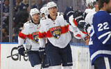 Florida Panthers skates players skate by the team bench and celebrates a goal with teammates during the second period in Game Five of the Second Round of the 2025 Stanley Cup Playoffs against the Toronto Maple Leafs at Scotiabank Arena in Toronto, Ontario, Canada, on May 14, 2025.   (Claus Andersen/Getty Images/AFP)