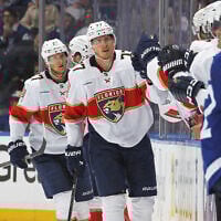 Florida Panthers skates players skate by the team bench and celebrates a goal with teammates during the second period in Game Five of the Second Round of the 2025 Stanley Cup Playoffs against the Toronto Maple Leafs at Scotiabank Arena in Toronto, Ontario, Canada, on May 14, 2025.   (Claus Andersen/Getty Images/AFP)