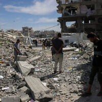 People inspect the damage amid the rubble of a building hit in an Israeli strike in Jabalia in the northern Gaza Strip on May 15, 2025. (BASHAR TALEB / AFP)
