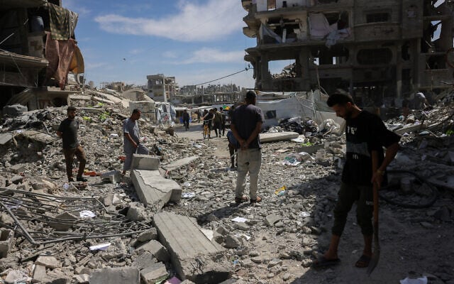 People inspect the damage amid the rubble of a building hit in an Israeli strike in Jabalia in the northern Gaza Strip on May 15, 2025. (BASHAR TALEB / AFP)