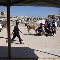 Palestinians transport their belongings as they flee Gaza City on May 16, 2025. (Bashar Taleb/AFP)