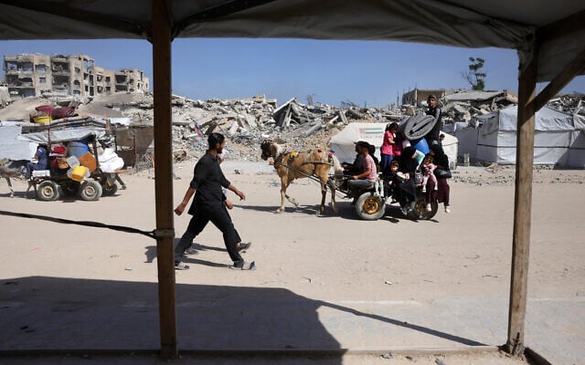 Palestinians transport their belongings as they flee Gaza City on May 16, 2025. (Bashar Taleb/AFP)