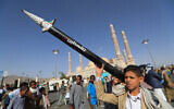 A Yemeni youth carries a mock missile during an anti-Israel rally in solidarity with Palestinians and the Gaza Strip, in the Houthi-run capital Sanaa, May 16, 2025. (Mohammed Huwais/AFP)