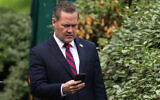 National Security Adviser Michael Waltz looks at his phone as he prepares for a TV interview at the White House on May 1, 2025, in Washington, DC. (Andrew Harnik / GETTY IMAGES NORTH AMERICA/AFP)