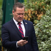 National Security Adviser Michael Waltz looks at his phone as he prepares for a TV interview at the White House on May 1, 2025, in Washington, DC. (Andrew Harnik / GETTY IMAGES NORTH AMERICA/AFP)